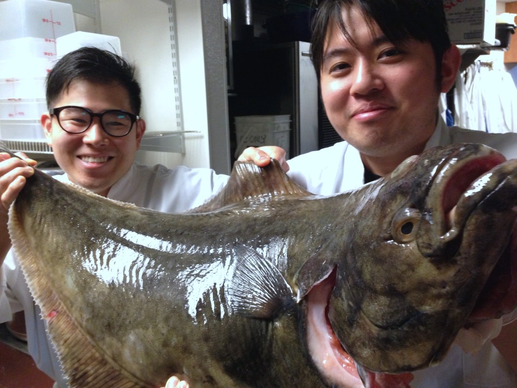 The staff at Sushi Kappo Tamura getting up close and personal with their new halibut friend. Photo courtesy of Sushi Kappo Tamura.