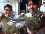 The staff at Sushi Kappo Tamura getting up close and personal with their new halibut friend. Photo courtesy of Sushi Kappo Tamura.