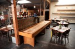 Brass Tacks is sparsely furnished with metal-legged wooden tables, which leaves room for a shuffleboard table, a foosball table and an upright piano.