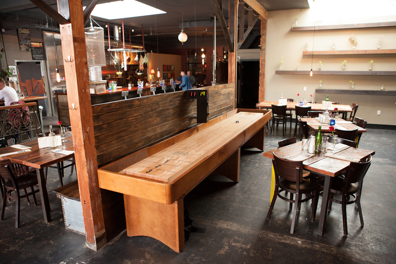 Brass Tacks is sparsely furnished with metal-legged wooden tables, which leaves room for a shuffleboard table, a foosball table and an upright piano.