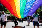 Marchers carry a large Pride flag at last weekend’s parade down Fourth Avenue, which came just four days after the U.S. Supreme Court struck down a federal law barring the U.S. government from recognizing same-sex marriages. Despite the ruling, many hurdles remain for equal treatment of gay couples.