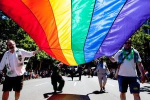 Marchers carry a large Pride flag at last weekend’s parade down Fourth Avenue, which came just four days after the U.S. Supreme Court struck down a federal law barring the U.S. government from recognizing same-sex marriages. Despite the ruling, many hurdles remain for equal treatment of gay couples.