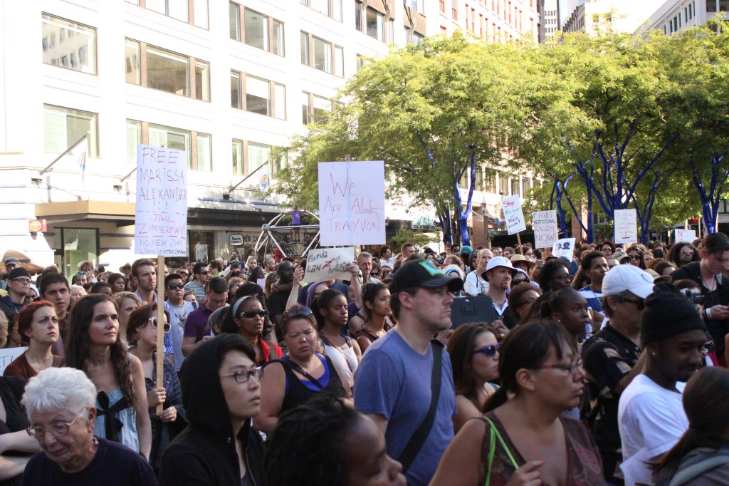 A young boy in a Huskies t-shirt tugs at the sleeve of