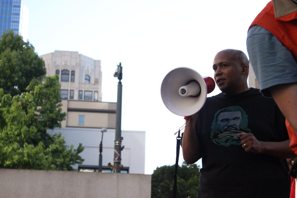 A young boy in a Huskies t-shirt tugs at the sleeve of