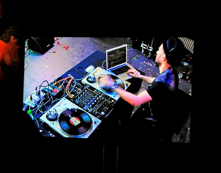 A-Trak on main stage, seen on screen at Caffe Vita