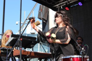 A dreadlocked older man covered in tattoos of mandalas and divine geometry
