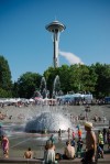 Families took a break to cool off in the The International Fountain of Seattle Center.