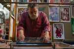 An artist creates a one of a kind Screen Print at Flatstock.
