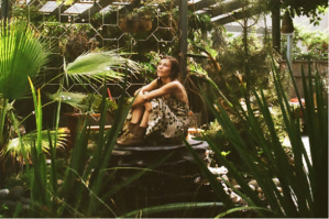 Mileece pondering what sounds might come out of all the green stuff surrounding her.