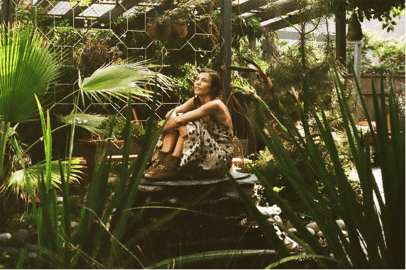 Mileece pondering what sounds might come out of all the green stuff surrounding her.