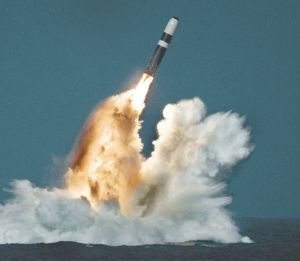 Under a full moon and floodlights, the perimeter fence of Naval Base