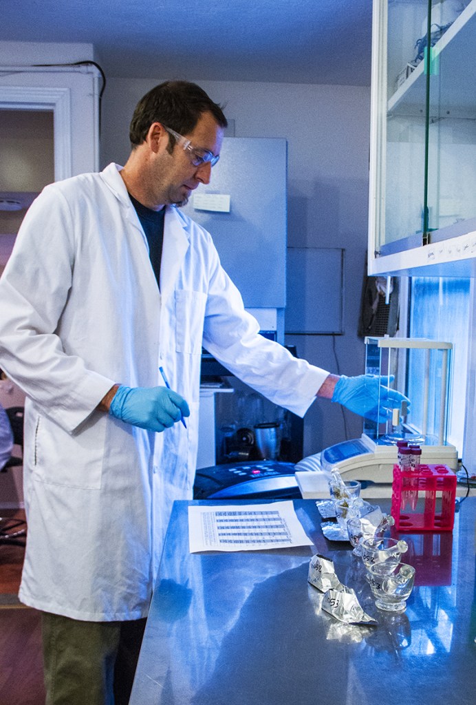 Analytical 360's Brenton Dawber runs a test on strains of marijuana. The Wallingford company tests the potency and pathogens in marijuana.