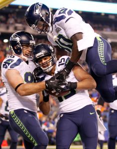 Seahawks wide receiver Jermaine Kearse celebrates his third quarter touchdown reception against the Denver Broncos with Seahawks tight end Zach Miller and Seahawks running back Derrick Coleman in Super Bowl XLVIII at MetLife Stadium. Photo by Jennifer Buchanan of The Daily Herald