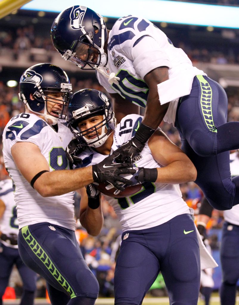Seahawks wide receiver Jermaine Kearse celebrates his third quarter touchdown reception against the Denver Broncos with Seahawks tight end Zach Miller and Seahawks running back Derrick Coleman in Super Bowl XLVIII at MetLife Stadium. Photo by Jennifer Buchanan of The Daily Herald