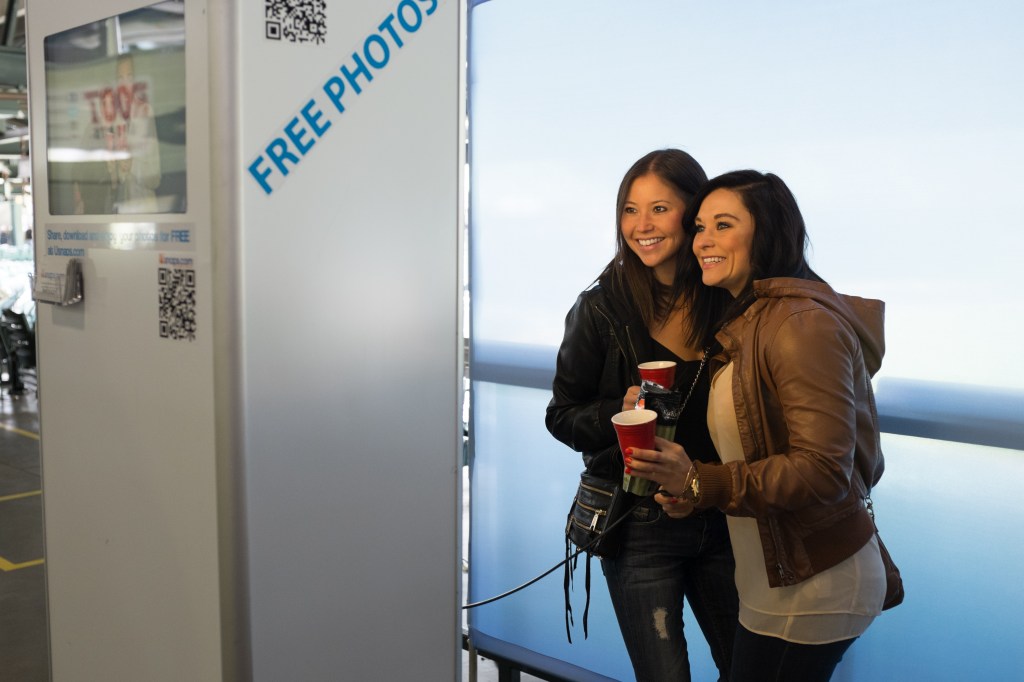 Alyse Hayashi, left, and Meagan Rosson, right, pose at a photobooth at the Bacon and Beer Classic.