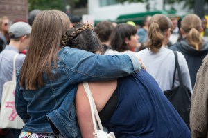 Participants lean on each other at the Mothers for Police Accountability vigil in solidarity with Ferguson, MO. Photo by Morgen Schuler