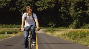 A stranger (Ian Edlund) rides into town in The New West.