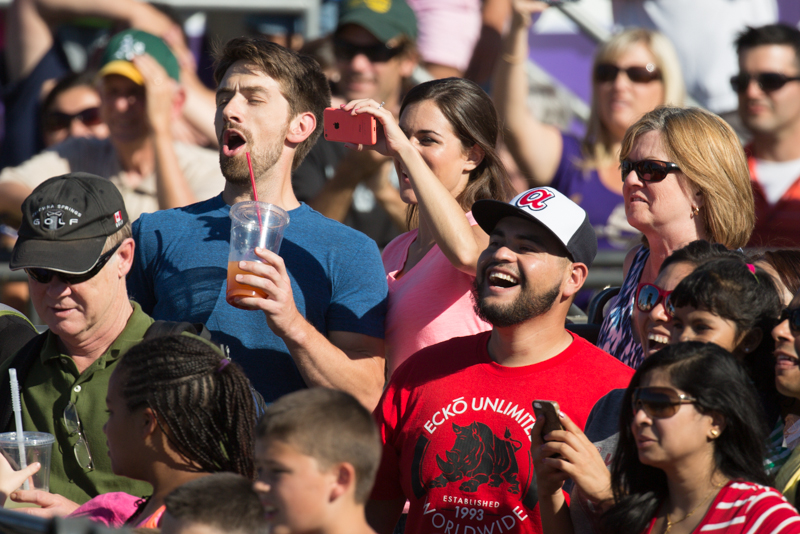The crowd cheers a rider.