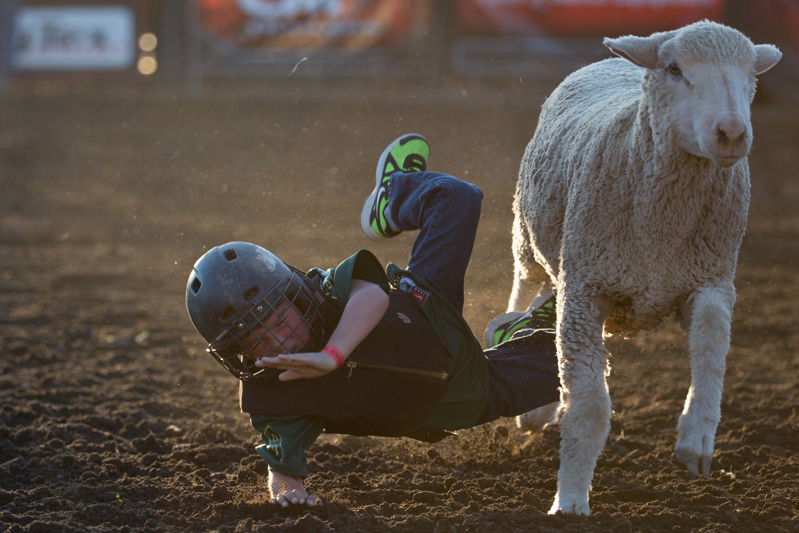 Bracing for impact, a child falls into the dirt.