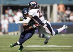 Hawks' receiver Doug Baldwin is tackled by Denver CB Bradley Roby in the second quarter. Baldwin picked up 14 on the play.