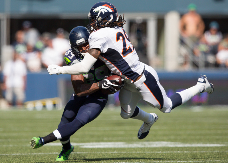 Hawks' receiver Doug Baldwin is tackled by Denver CB Bradley Roby in the second quarter. Baldwin picked up 14 on the play.