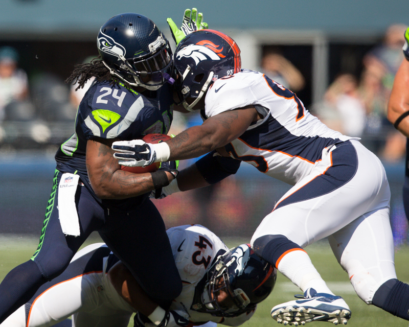 Lynch attempts to break a tackle.