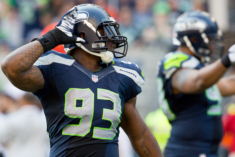 Seattle defensive end O'Brien Schofield asks the 12th Man to kick it up a notch as Denver rallies in the fourth.
