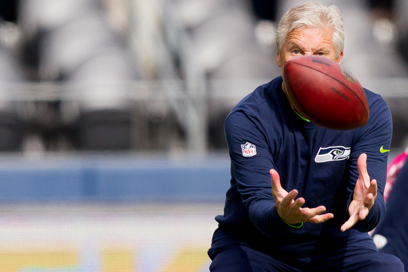 Seattle head coach Pete Carroll catches a pass during pre-game practice.