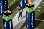Seattle star running back Marshawn Lynch pumps up the crowd as he takes the field before the game.