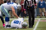 Dallas quarterback Tony Romo lies on the field after taking a big hit in the first quarter.