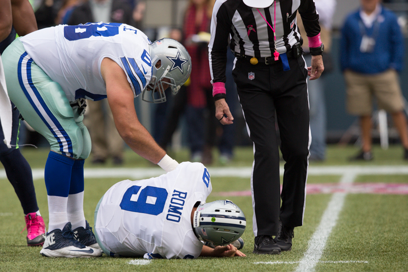 Dallas quarterback Tony Romo lies on the field after taking a big hit in the first quarter.