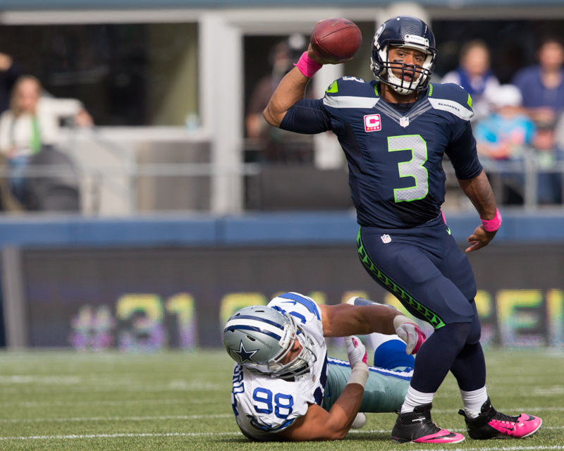 Seahawks' quarterback Russell Wilson tosses the ball away under pressure.