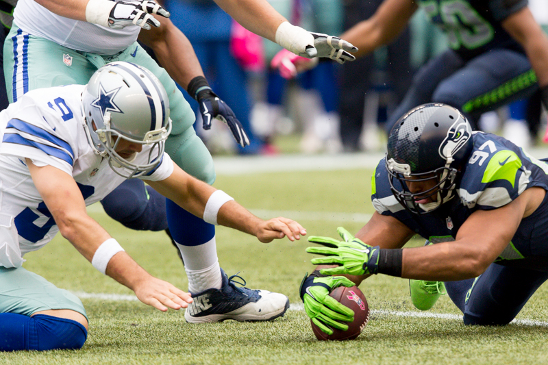 Seattle defensive tackle Jordan Hill recovers a Tony Romo snap fumble in the third quarter.