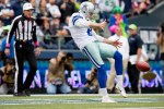 Dallas punter Chris Jones punts the ball off to Seattle wide receiver Bryan Walters in the fourth quarter.