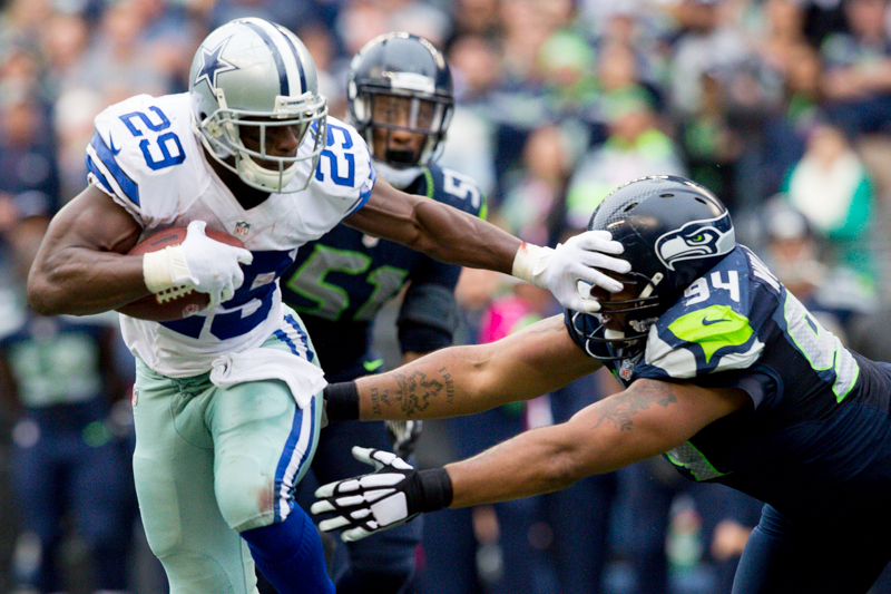 Dallas running back DeMarco Murrary stiff arms Seattle defender Kevin WIlliams late in the fourth quarter.