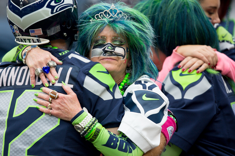 Seattle fans embrace after Sunday's 30-23 loss to the Dallas Cowboys.