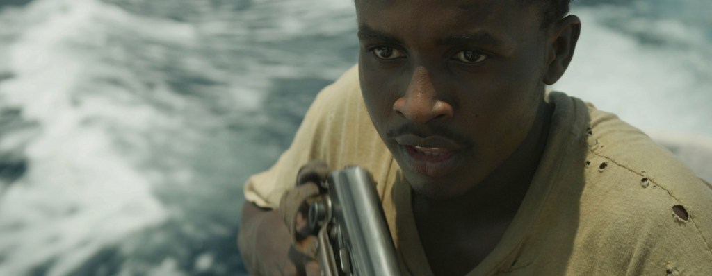 Abdi (Muktar) nervously handles his AK-47.