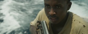 Abdi (Muktar) nervously handles his AK-47.