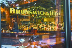 A circa-1900 landscape painting reflected in the beautiful bar. Below left: duck au poivre. Below right: oxtail with pasta.