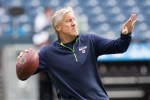Seahawks' head coach Pete Carroll throws a pass in pre-game practice.