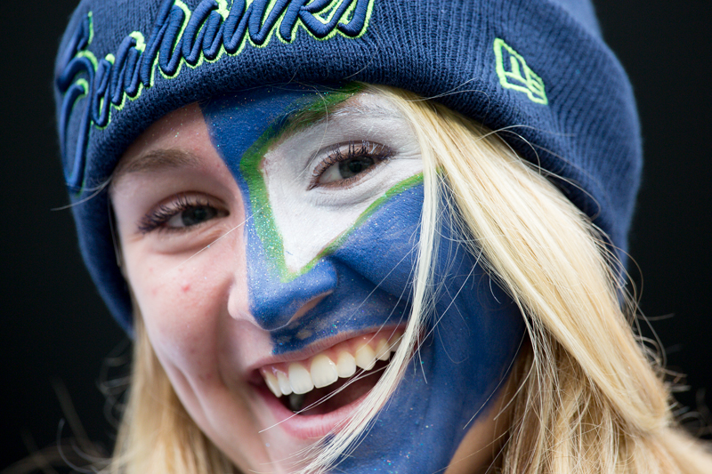 A fan, decked out in face-paint, awaits the beginning of the game.