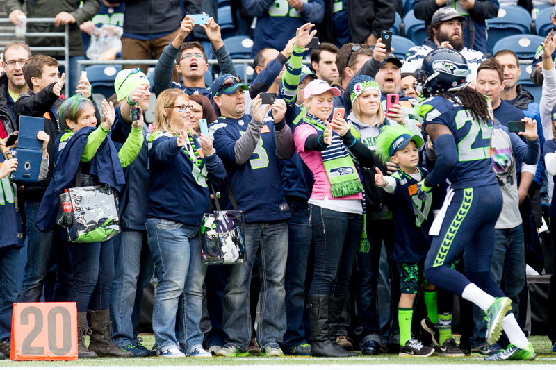 Fans on the sidelines greet Seattle cornerback Richard Sherman as he rounds the sidelines before the game.