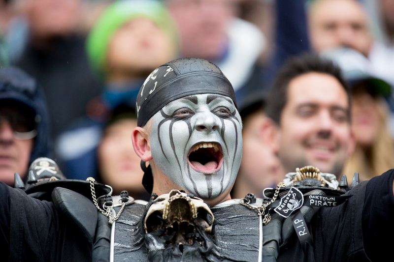 Dressed in an intimidating get-up, a Raiders fan cheers the team's first-quarter field goal.