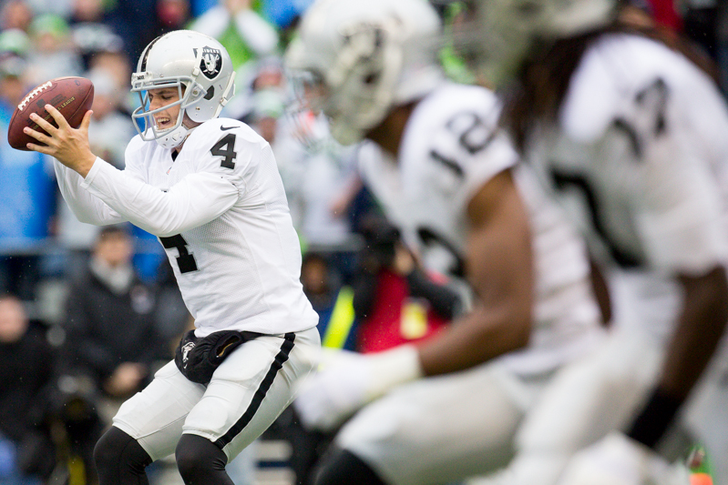 Raiders' quarterback Derek Carr takes a snap in the first quarter, only to be picked off by linebacker Bruce Irvin.
