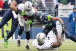 Raiders' wide receiver James Jones is tackled by Seahawks' linebacker KJ Wright for a gain of six in the second quarter.