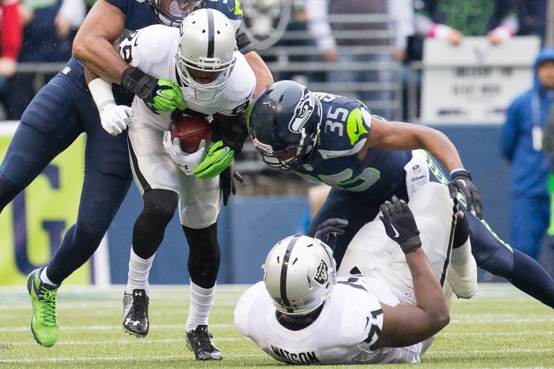 Raiders' wide receiver James Jones is tackled by Seahawks' linebacker KJ Wright for a gain of six in the second quarter.