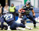 Hawk's receiver Doug Baldwin struggles to gain turf on a 20-yard catch in the second quarter.