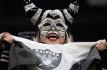 A Raiders fan cheers for her team.