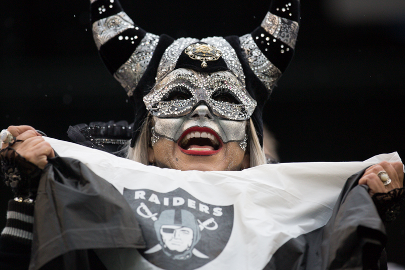 A Raiders fan cheers for her team.