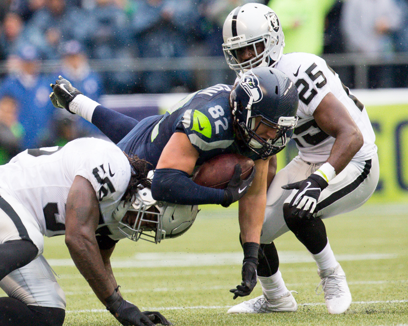 Seattle tight-end Luke Willson is upended by an Oakland defender on a 16 yard pass in the second quarter.